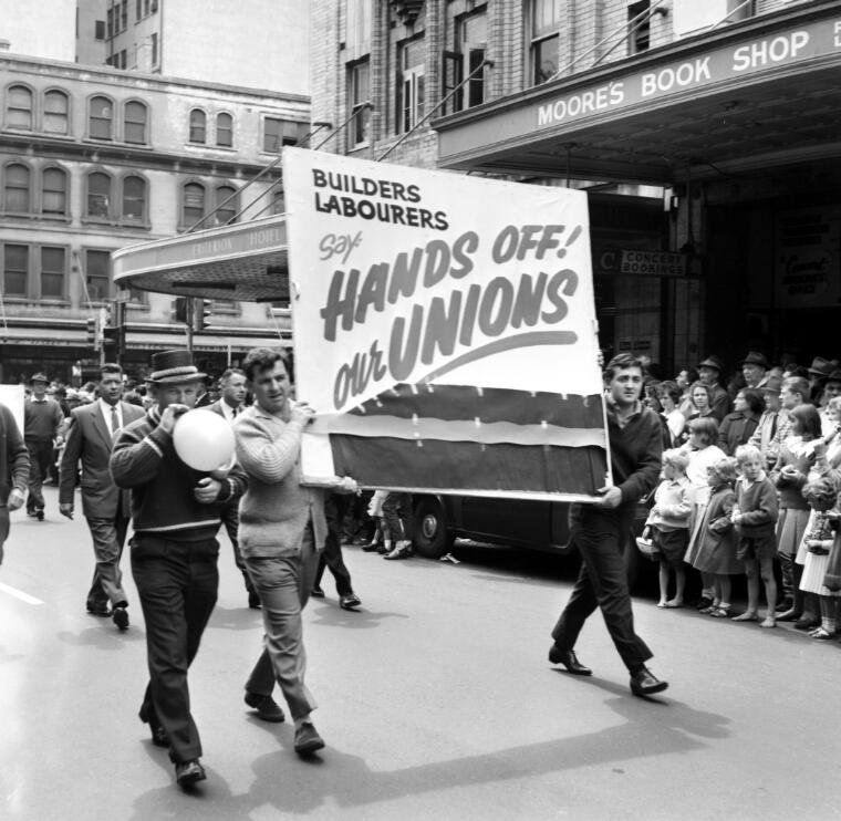 # McQuillan, Ern, 1926- # Member of the Builders Labourers Union carrying a banner on the 6 Hour March, Sydney, 6 October 1964
