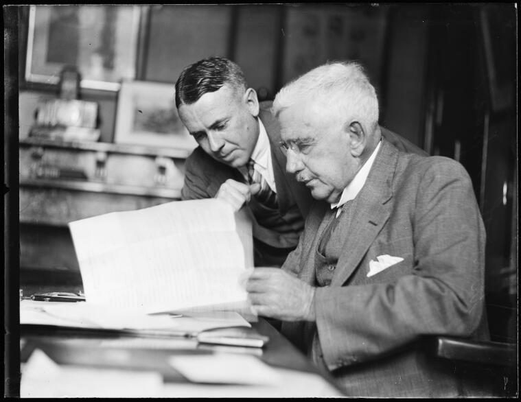 Mr W.M. Thompson and Dr Forster examining papers at the Benevolent Society Rooms