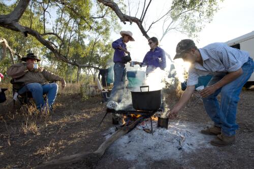 The Darcy family preparing breakfast on a campfire at Mallapunyah Station, Barkly Tablelands, Northern Territory, 25 June 2016 / Darren Clark