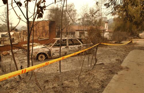 [Burnt car and houses in Duffy, Canberra, January 2003, 1] [picture] / Damian McDonald