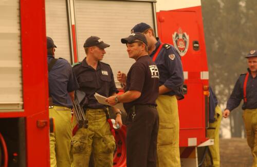 [Fire crew next to a fire engine in Duffy, Canberra, January 2003] [picture] / Damian McDonald