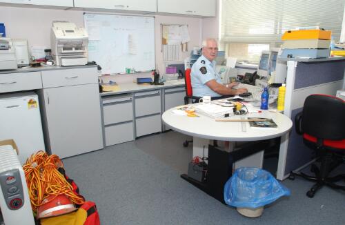 [A police officer at his office, Curtin, Canberra, January 2003] [picture] / Damian McDonald