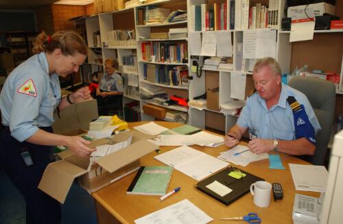 [Three officers at work, Curtin, Canberra, January 2003] [picture] / Damian McDonald
