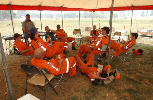 Fire fighters taking a rest break under shading at Curtin, Canberra, January 2003] [picture] / Damian McDonald