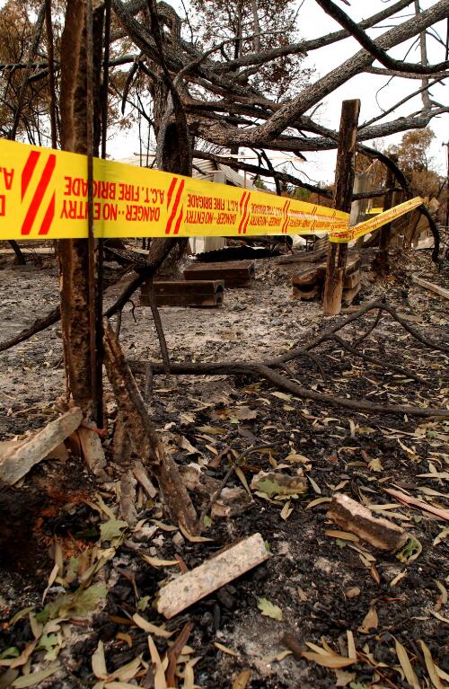 [A.C.T. Fire Brigade's no entry tape tied around a burnt house, Canberra, January 2003, 1] [picture] / Loui Seselja