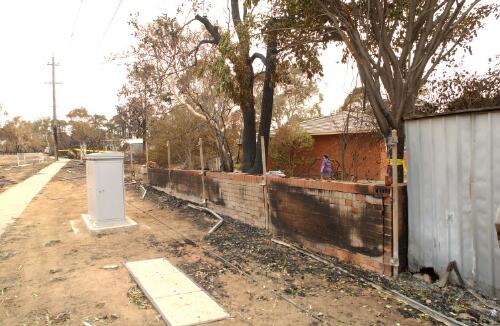 [Fire damaged brick wall and garden shed in Kambah, Canberra, January 2003] [picture] / Loui Seselja