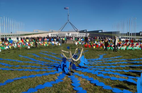 [Display representing a refugee boat on a sea of blue hearts in front of Parliament House, United Nations World Refugee Day and Field of Hearts event, Canberra, 20 June 2004] [picture] / Loui Seselja