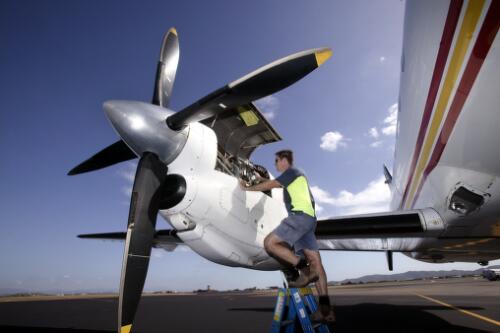 Darren Wintour, Engineer, inspects an engine of  MacAir Airlines' SAAB 340 VH-UYC 'Gurambilbarra' following arrival at Townsville International Airport, Townsville, Queensland, 30 May 2005 [picture] / Loui Seselja