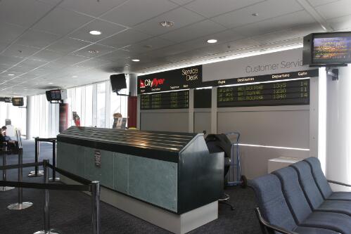 The Qantas Cityflyer service desk inside Canberra Airport passenger terminal departure lounge, 8 June 2005 [picture] / Loui Seselja