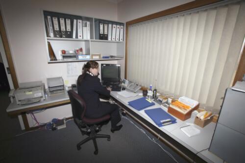 Air Link Airlines' staff member Keiran Baggott records a booking at the Reservations Centre of the Air Link Head Office, Dubbo Airport, New South Wales, 9 June 2005 [picture] / Loui Seselja