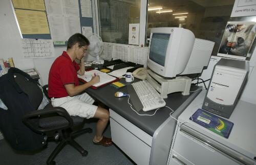 Dr Mel Scrase receives an emergency call at the Royal Flying Doctor Service of Australia's Cairns Base, Edge Hill, Cairns, Queensland, 16 June 2005 [picture] / Loui Seselja