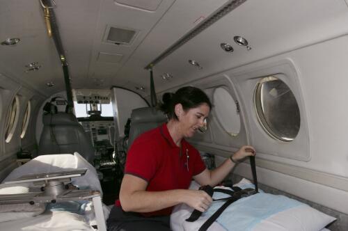 Flight Nurse Briody Main prepares to transfer a patient from Cairns to Townsville Hospital in the Royal Flying Doctor Service of Australia's Beechcraft King Air 200, VH-FDF, Cairns Airport, Cairns, Queensland, 16 June 2005 [picture] / Loui Seselja