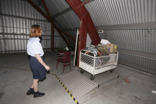 Flight Nurse Gayle Rusher weighs medical equipment prior to loading onto a Cessna 404, VH-TFO, operated by Hinterland Aviation for the Royal Flying Doctor Service of Australia's clinic flights to Einasleigh, Georgetown and Croydon, Cairns Airport, Cairns, Queensland, 16 June 2005 [picture] / Loui Seselja