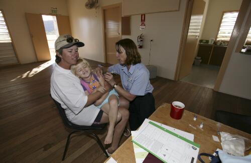 Flight Nurse Gayle Rusher immunises a child as part of the National Immunisation Program at the Royal Flying Doctor Service of Australia's clinic at Einasleigh Town Hall, Einasleigh, Queensland, 16 June 2005 [picture] / Loui Seselja