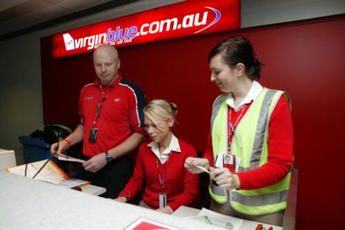Virgin Blue staff at the departure lounge counter, Tullamarine Airport, Melbourne, 21 June 2005 picture] / Damian McDonald