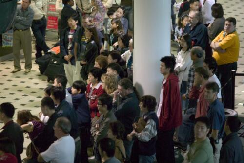 People gathering at the arrivals gate, Brisbane International Airport, 1 July 2005 [picture] / Greg Power