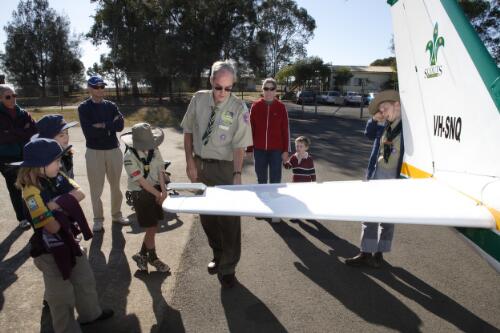 Pilot Graham Bentley explaining the function of the planes elevators to group of scouts outside Scouts Australia Air Activities Centre hangar at Camden Airport, 30 July 2005, [2] [picture] / Damian McDonald