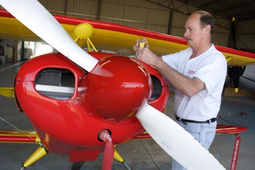David Dent working on Pitts S1 stunt plane engine in Dent Aviation hangar at Camden Airport, 30 July 2005, [1] [picture] / Damian McDonald