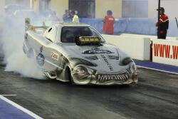 Driver Ben Bray lights up the rear wheels of his Top Alcohol drag car ...