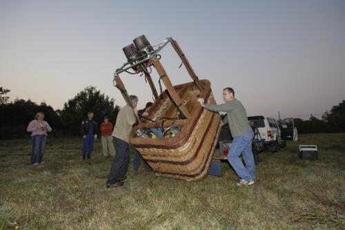 Three crew members from Balloon Aloft unloading a wicker balloon basket from a trailer during the Canberra Balloon Fiesta, Canberra, April 2007 [picture] / Loui Seselja