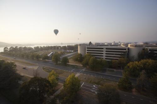 Hot air balloons flying over Lake Burley Griffin, with the Edmund Barton building on left, Canberra, April 2007 [picture] / Loui Seselja