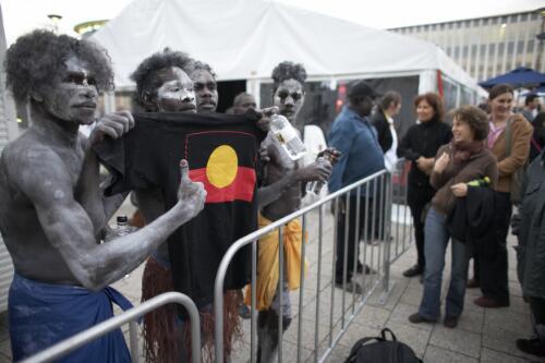 Chooky Dancers holding a t-shirt bearing the Aboriginal flag after their performance at the Fringe Festival as part of the National Multicultural Festival, Civic Square, Canberra, 8 February 2008 [picture] / Damian McDonald