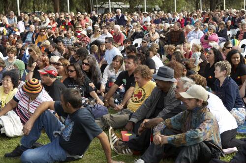 Crowd sitting on the lawns during the Apology to the Stolen Generations at Parliament House, Canberra, 13 February 2008 [picture] / Craig Mackenzie