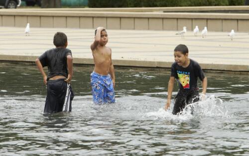 Three Aboriginal Australian children playing in the fountain during the occasion of the Apology to the Stolen Generations at Parliament House, Canberra, 13 February 2008 [picture] / Craig Mackenzie