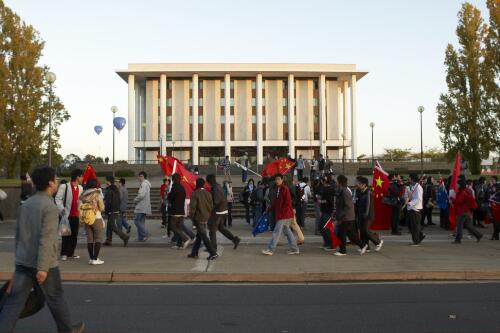 Chinese protesters walking past the National Library of Australia at the Torch Relay for the Beijing Olympic Games, Canberra, 24 April 2008 [picture] / Greg Power