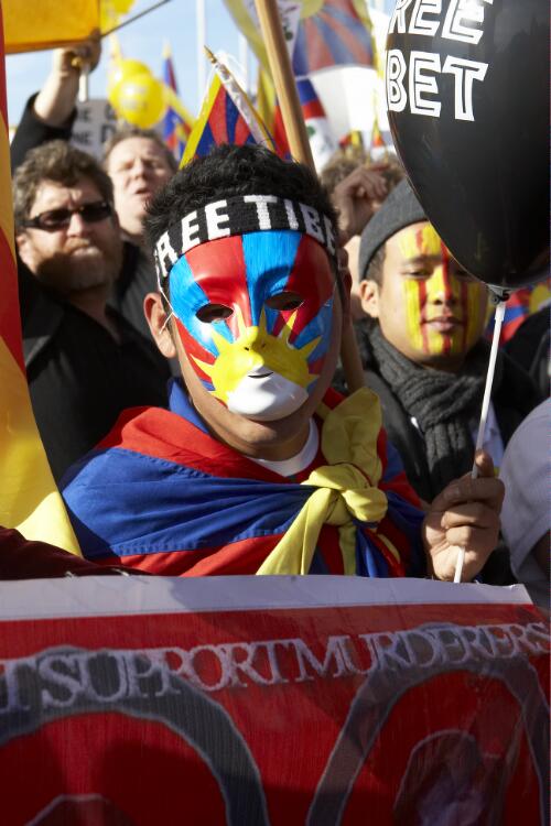 Protester wearing a mask painted as the Tibetan flag at the Torch Relay for the Beijing Olympic Games, Canberra, 24 April 2008 [picture] / Greg Power