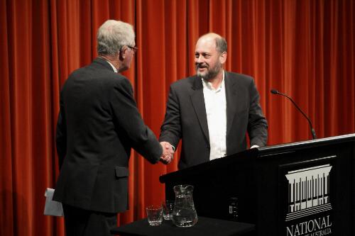 Greg Cornwell and Professor Tim Flannery shaking hands at the 2008 Kenneth Myer Lecture "Climate change: an update to July 2008" presented by Tim Flannery at the National Library of Australia, Canberra, 15 July 2008 [picture] / Sam Cooper