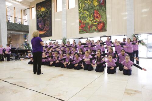 The Australian Girls Choir and their conductor performing in the National Library of Australia foyer during the National Tour 2010, 2 July 2010 / Craig Mackenzie