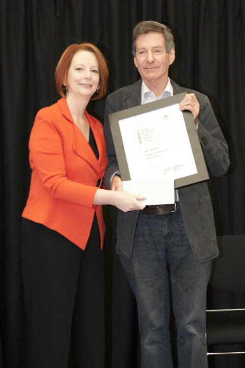 Prime Minister Julia Gillard presenting author Roger McDonald with his award at the Prime Minister's Literary Awards held at the National Library of Australia, Canberra, 8 July 2011 [picture] / Sam Cooper