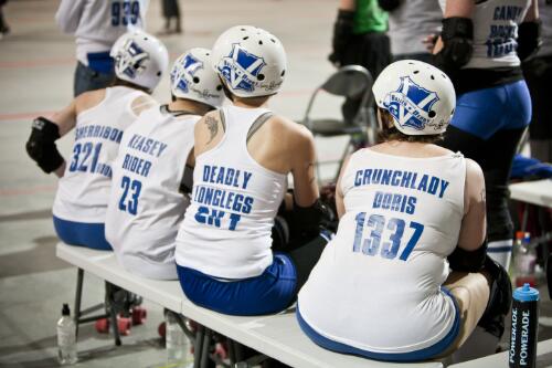 Four members of the Victorian Roller Derby team Queen Bees sitting on the team bench, Melbourne Showgrounds, Melbourne 23 July 2011 [picture] / Samuel Cooper