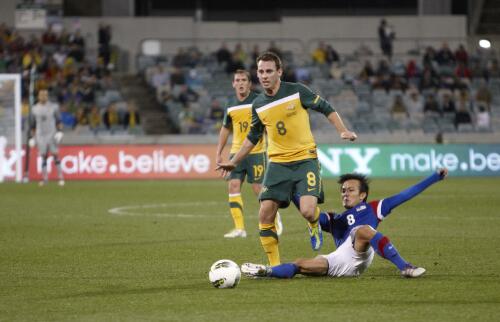 Joseph Kalang Tie sliding for the ball with Neil Kilkenny and Luke Wilkshire, Socceroos Australia v Malaysia soccer match, Canberra Stadium, Canberra, 7 October 2011 [picture] / Greg Power