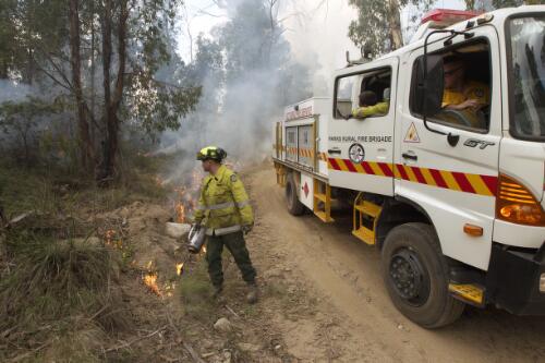 Fire fighter from ACT Parks and Conservation Service starting the controlled burn in Namadgi National Park, Australian Capital Territory, 2013 / Lannon Harley
