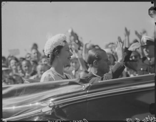 Queen Elizabeth II and Prince Philip viewing the crowd from an open-top car, Melbourne, Victoria, February 1963, 1