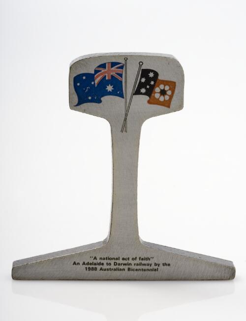 [Piece of metal in the shape of a rail inscribed: A national act of faith, an Adelaide to Darwin railway by the 1988 Australian Bicentennial] [realia]