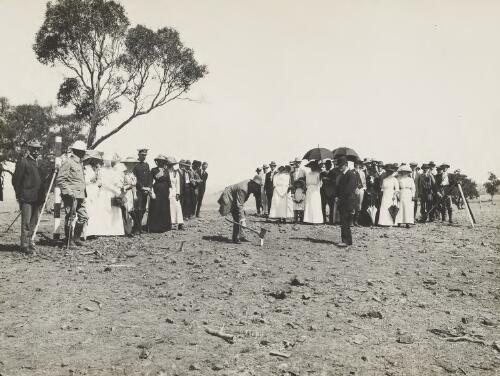 The Honourable King O'Malley, Minister of State for Home Affairs, driving the first survey peg at Canberra Hill, in connection with the lay-out of the Federal City, on 20th Februaury, 1913 [picture]