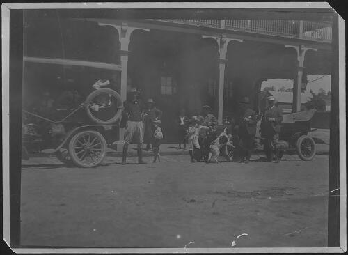 Banjo Paterson and group in street [picture]