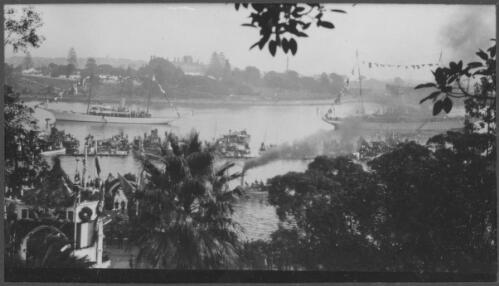 [Flotilla of assorted ships, in front left of photograph is the Royal Barge steaming towards the landing stage at Farm Cove where His Royal Highness arrived during visit to Sydney of H.R.H. the Prince of Wales, June - July 1920] [picture]