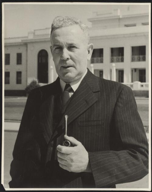 Portrait of J. B. Chifley [standing at the front of Old Parliament House, Canberra] [picture]