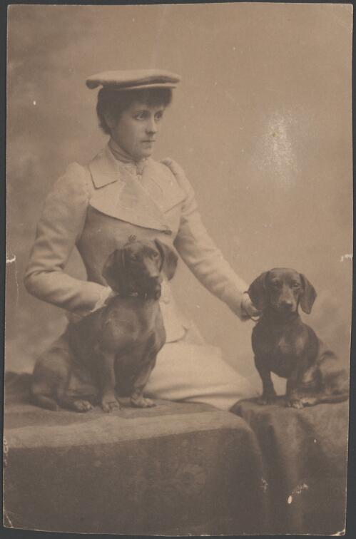 Portrait of Hersey Hopetoun, Marchioness of Linlithgow and her dogs [dachshunds] [picture]