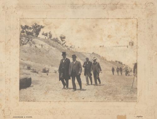 Portrait of Sir John Forrest with Sir William Lyne inspecting Mundaring Weir, W.A. [picture] / Greenham and Evans