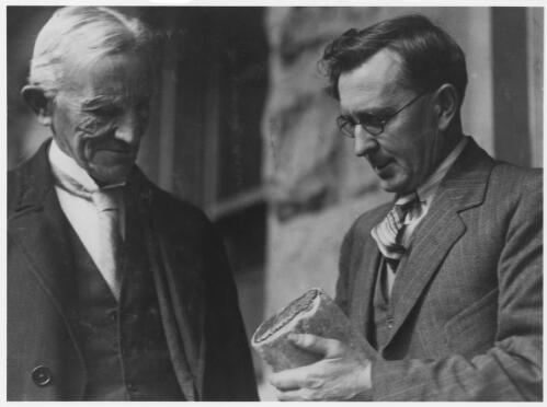 Sir Edgeworth David and Dr. Charles Fenner examining a specimen of fossilized wood, South Australia, early 1930s [picture]