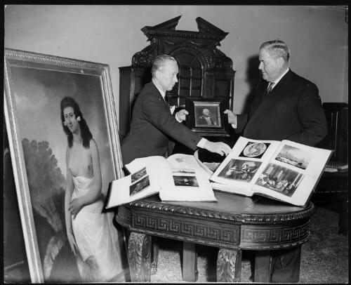 Portrait of  Rex Nan Kivell (left) handing over his collection of early Australian items to Senator the Hon. Sir Alistair [i.e. Alister] McMullin, President of the Senate, at a ceremony at Australia House, 16 January 1959 [picture] / Sport & General Press Agency Limited