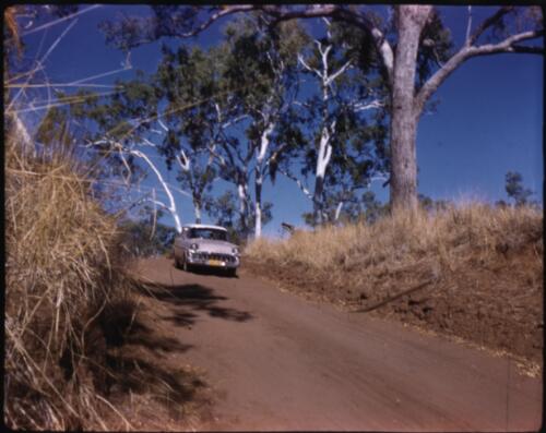 [Holden car on a dirt track, Northern Territory] [transparency] / [Frank Hurley]