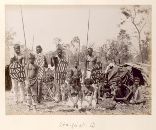 [Group of twelve unidentified Aboriginal men, women and children, with men and boys holding spears and shields, Queensland] [picture]
