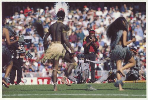 [Archie Roach and dancers performing at the Australian Football League grand final, 1993] [picture] / [Tim Webster]