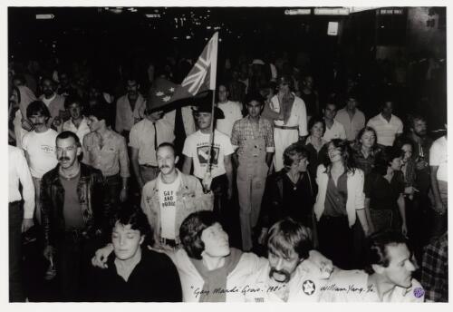 [Man holding an Australian flag and wearing a t-shirt with the phrase, gay and proud], Gay Mardi Gras, 1981 [picture] / William Yang